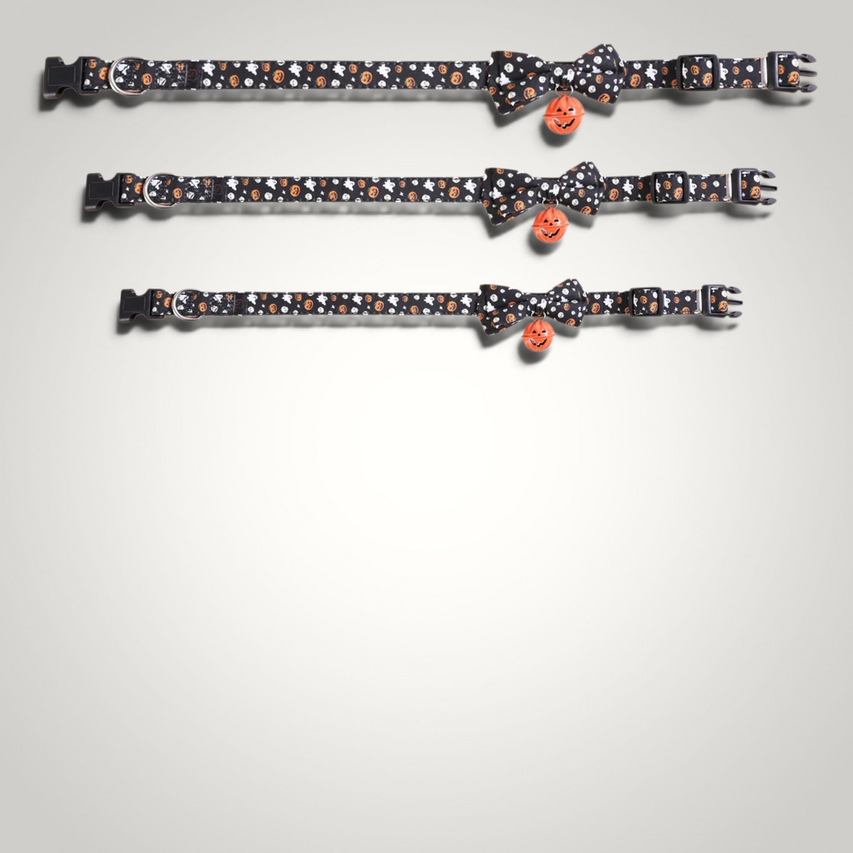 HappiFinds Halloween cat collars in black with pumpkin and ghost print, featuring a bow tie and pumpkin jingle bell.