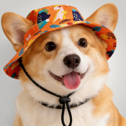 HappiFinds dog sun hat in orange with dinosaur print worn by a happy corgi with an adjustable chin strap