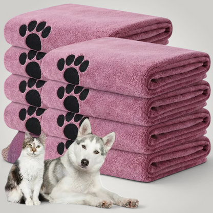 HappiFinds soft pink microfiber dog bath towels with black paw print patterns, stacked with a cat and husky dog.