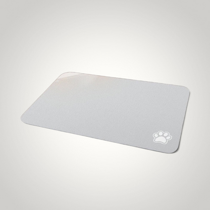 HappiFinds light gray waterproof dog feeding mat with a white paw print design and non-slip rubber backing.