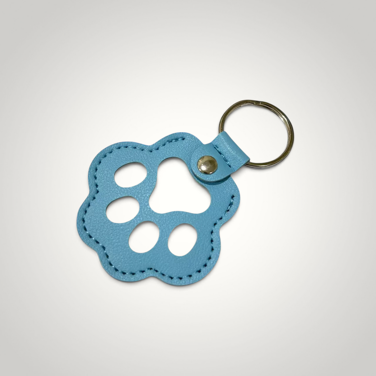 HappiFinds light blue faux leather paw print keychain for removing pet hair from clothing and upholstery