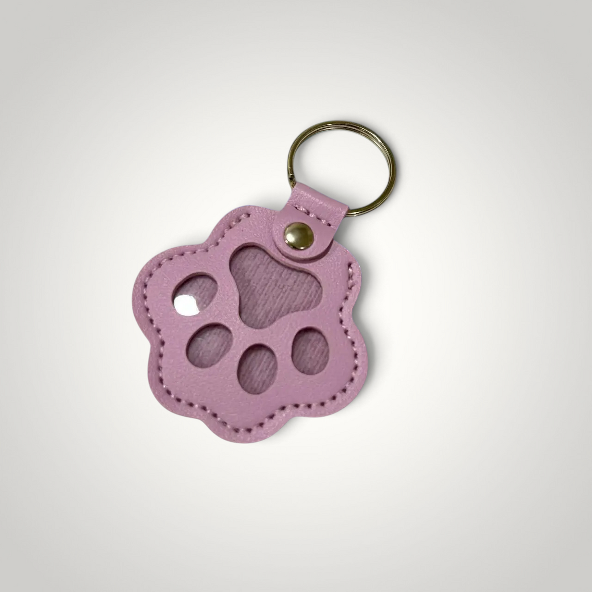 HappiFinds pink faux leather paw-print dog hair collector keychain with a sturdy metal ring for portable lint removal.