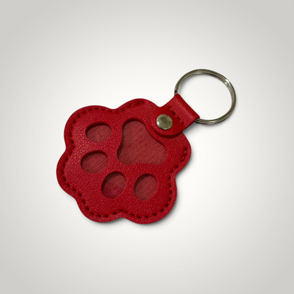 HappiFinds red faux leather paw print dog hair collector keychain with a metal ring for keys or bags.